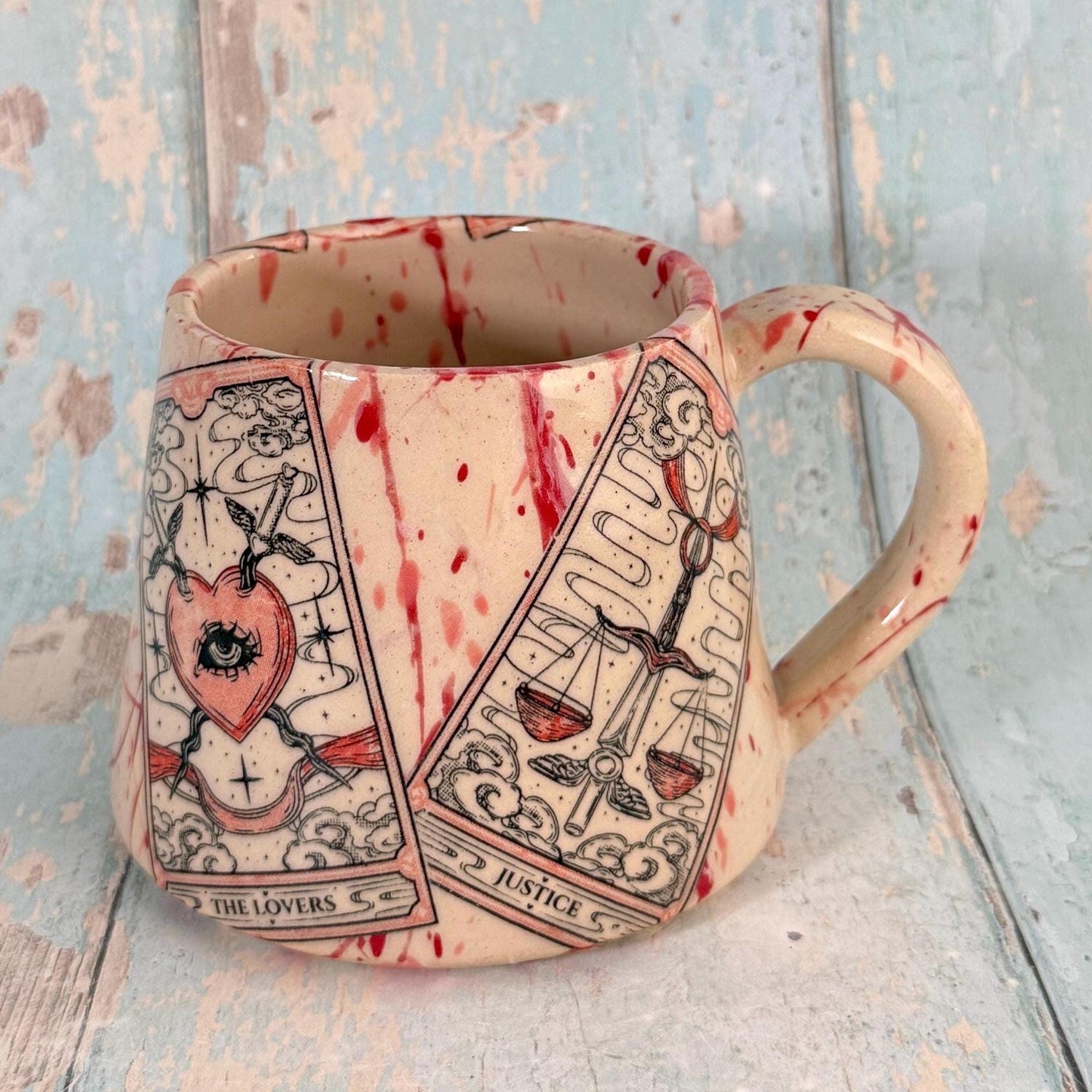 Mug with tarot card designs on a textured surface