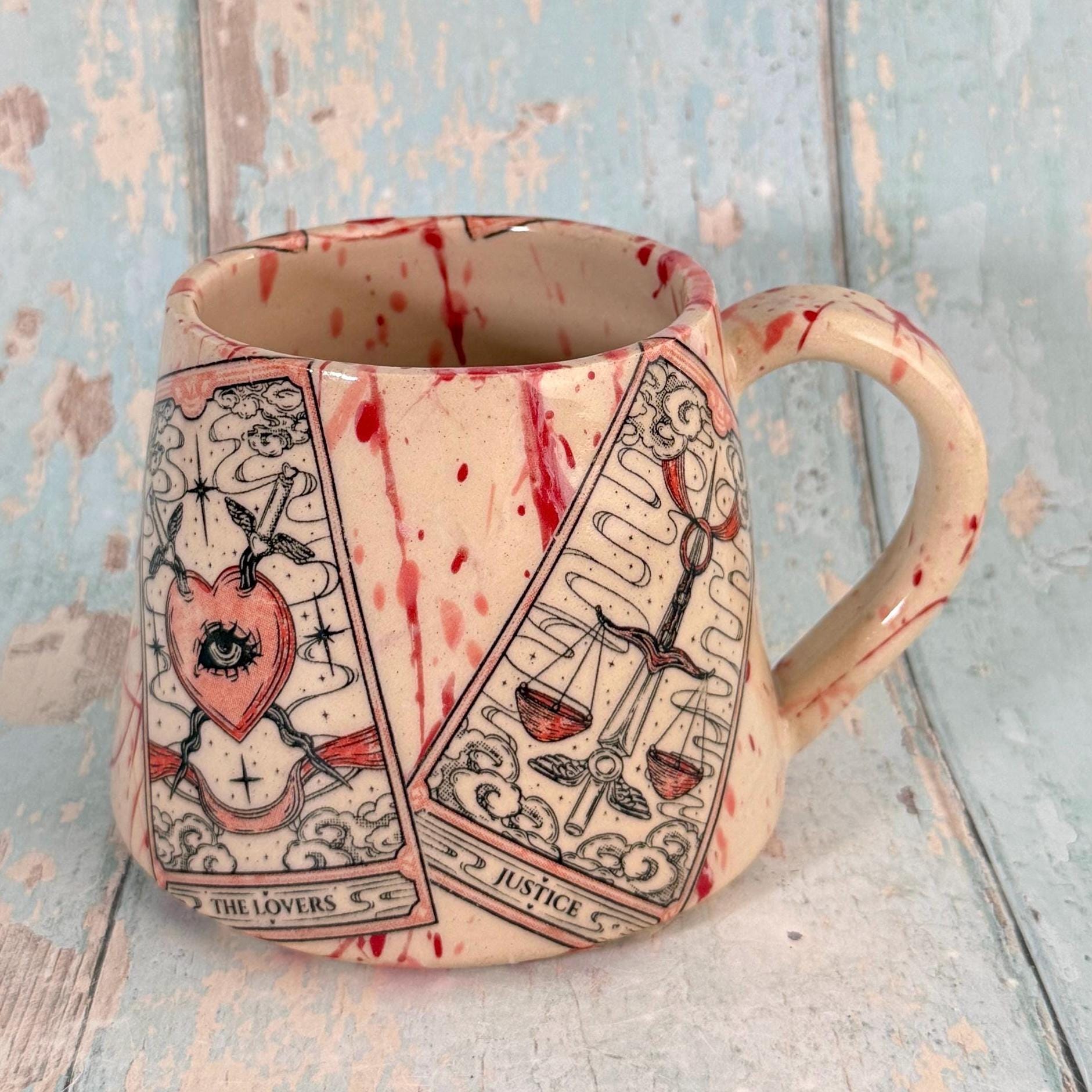 Mug with tarot card designs on a textured surface