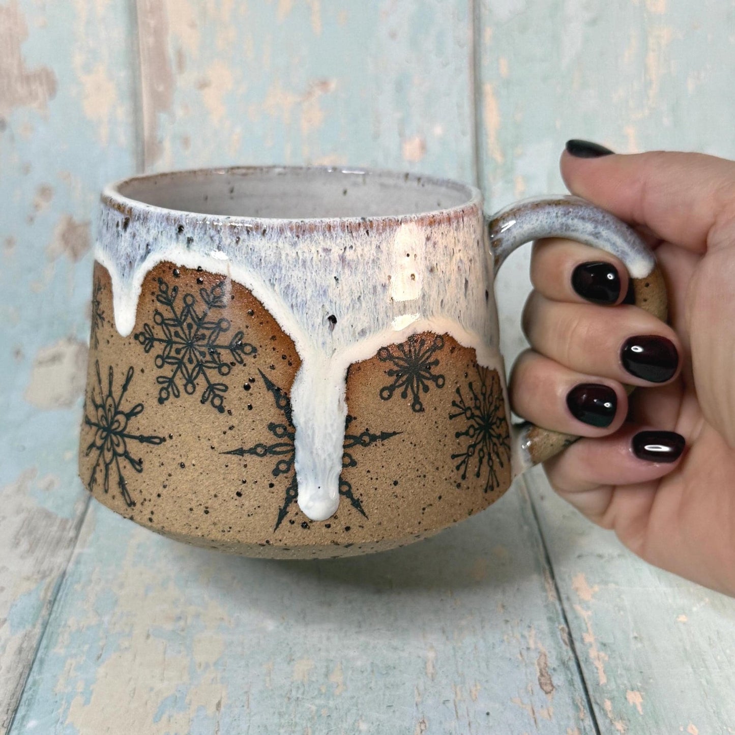 Festive ceramic cup showing snowflake detail
