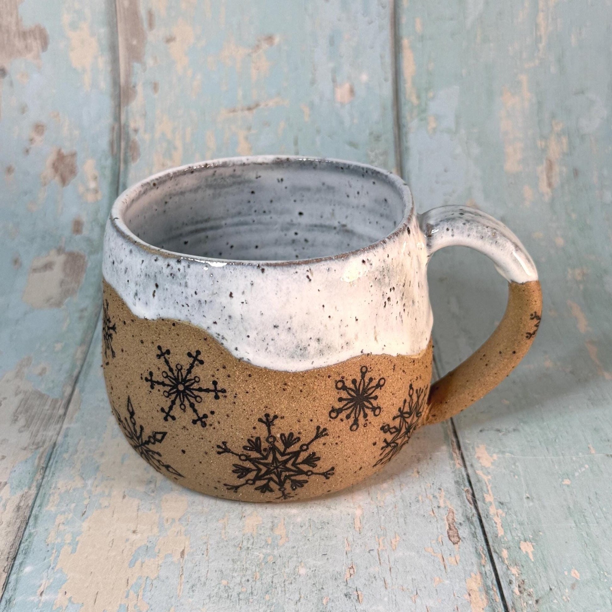 Hand-thrown winter mug with snowflake pattern

