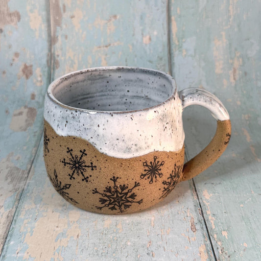 Hand-thrown winter mug with snowflake pattern
