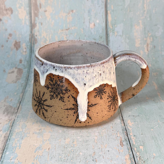 Hand-thrown winter mug with snowflake pattern
