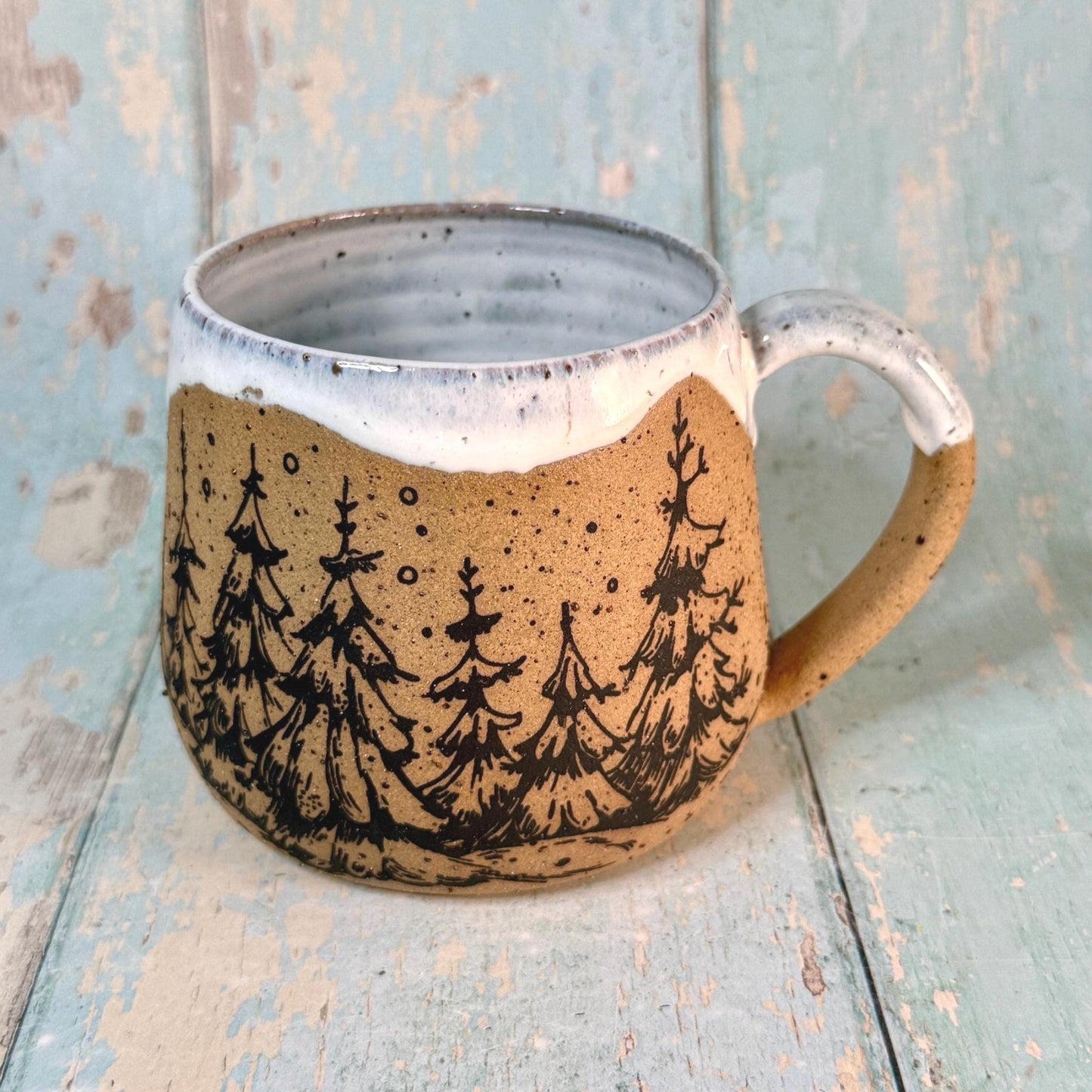 Handmade ceramic mug with black Christmas tree design and white glaze